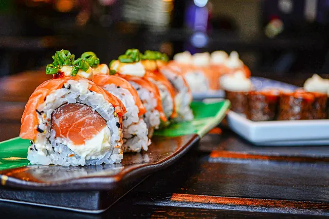 Salmon sushi rolls served on a wooden board